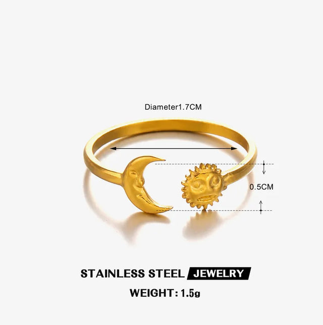 Gold and silver open ringwith sun and moon design on a soft white background