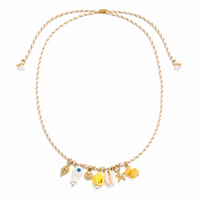 Gold necklace with various charms on a white background
